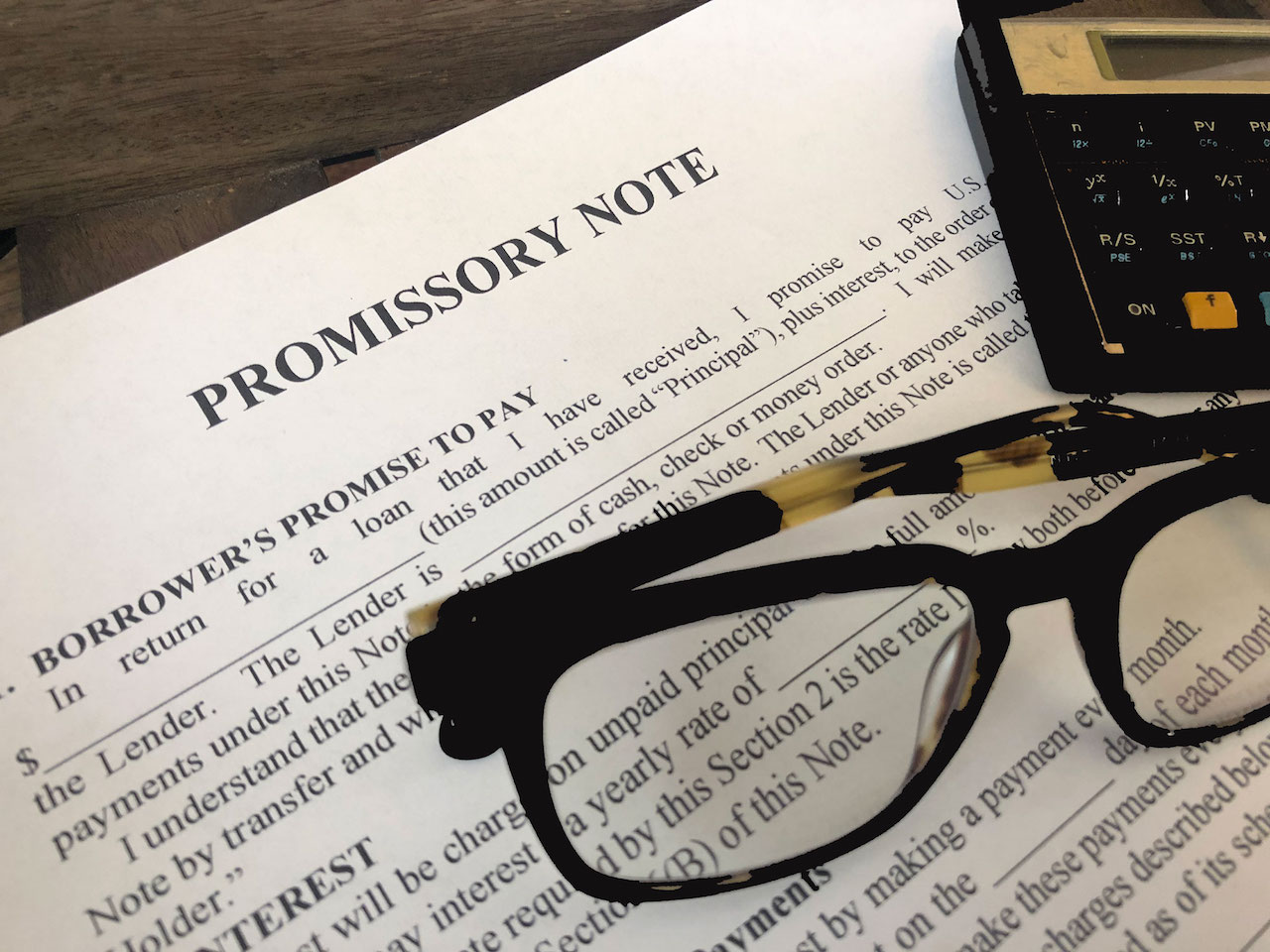 Promissory note with glasses and calculator